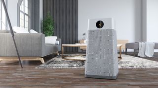 An air purifier standing in the middle of a living room