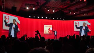 A photograph of Qualcomm senior vice-president of engineering, Chris Patrick, holding a Snapdragon 8 Gen 2 chip