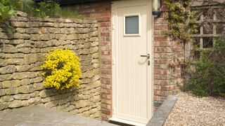 cream front door on traditional cottage with thermal efficiency