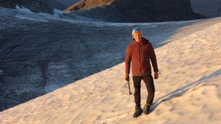 Man wearing an Artilect M-Divide Fusion Stretch Hoodie in the Alps