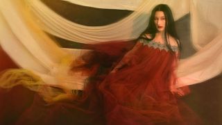 Zola Jesus in a red chiffon gown