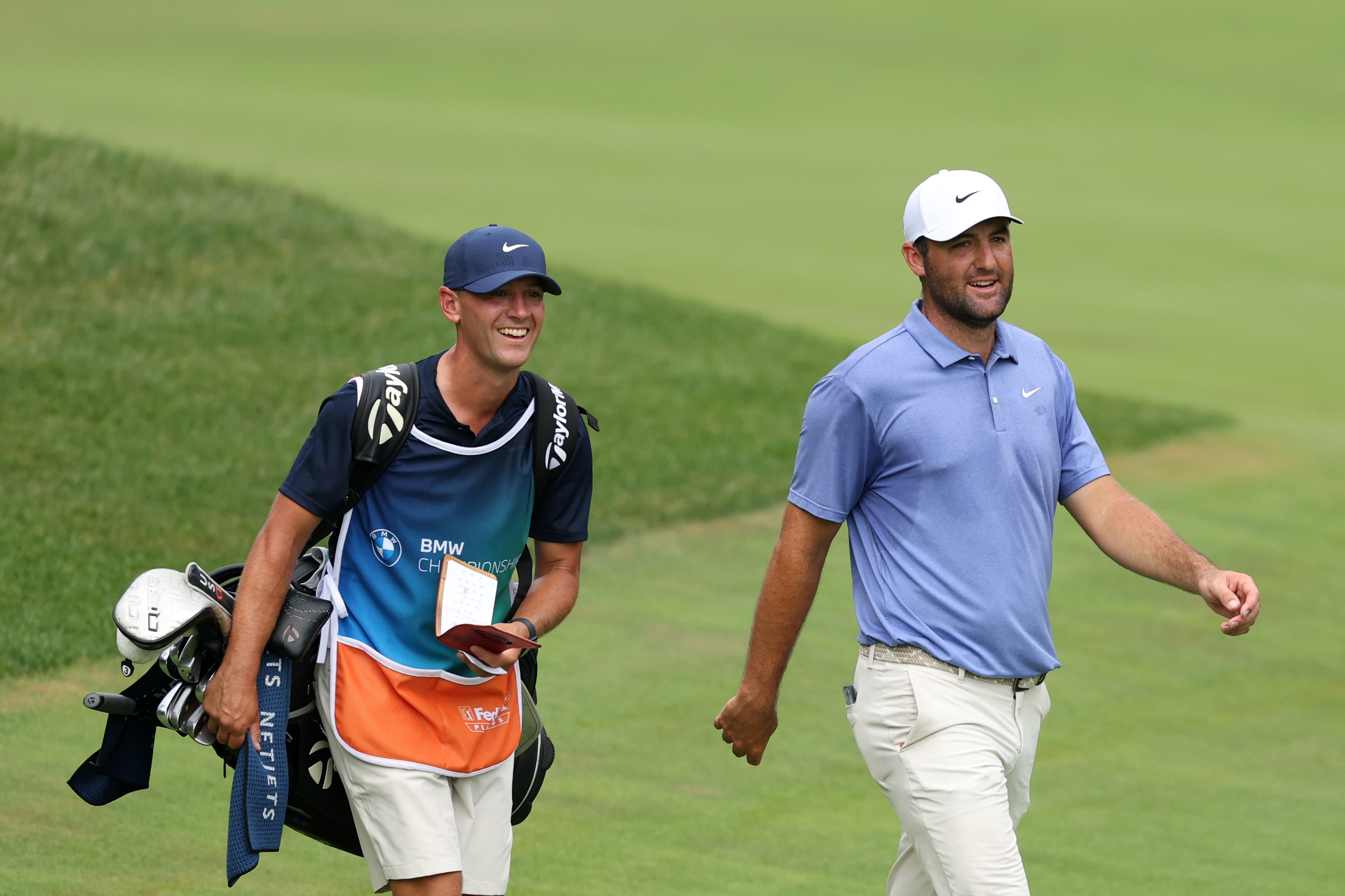 Michael Cromie (left) and Scottie Scheffler walk along during the 2025 BMW Championship