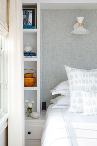 bedhead with build in shelves in white with grey textured wallpaper at bedhead