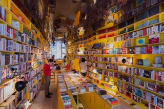 Librería's maze-like interiors, filled with colorful books and reflective surfaces.