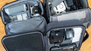 DJI Mini 3 Pro and Autel Lite and Bwine drones in bags close crop
