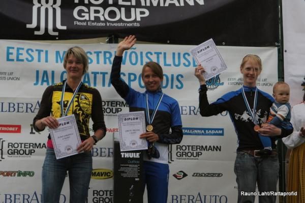 The women's podium, with Treier showing off her new blue, black and white jersey.