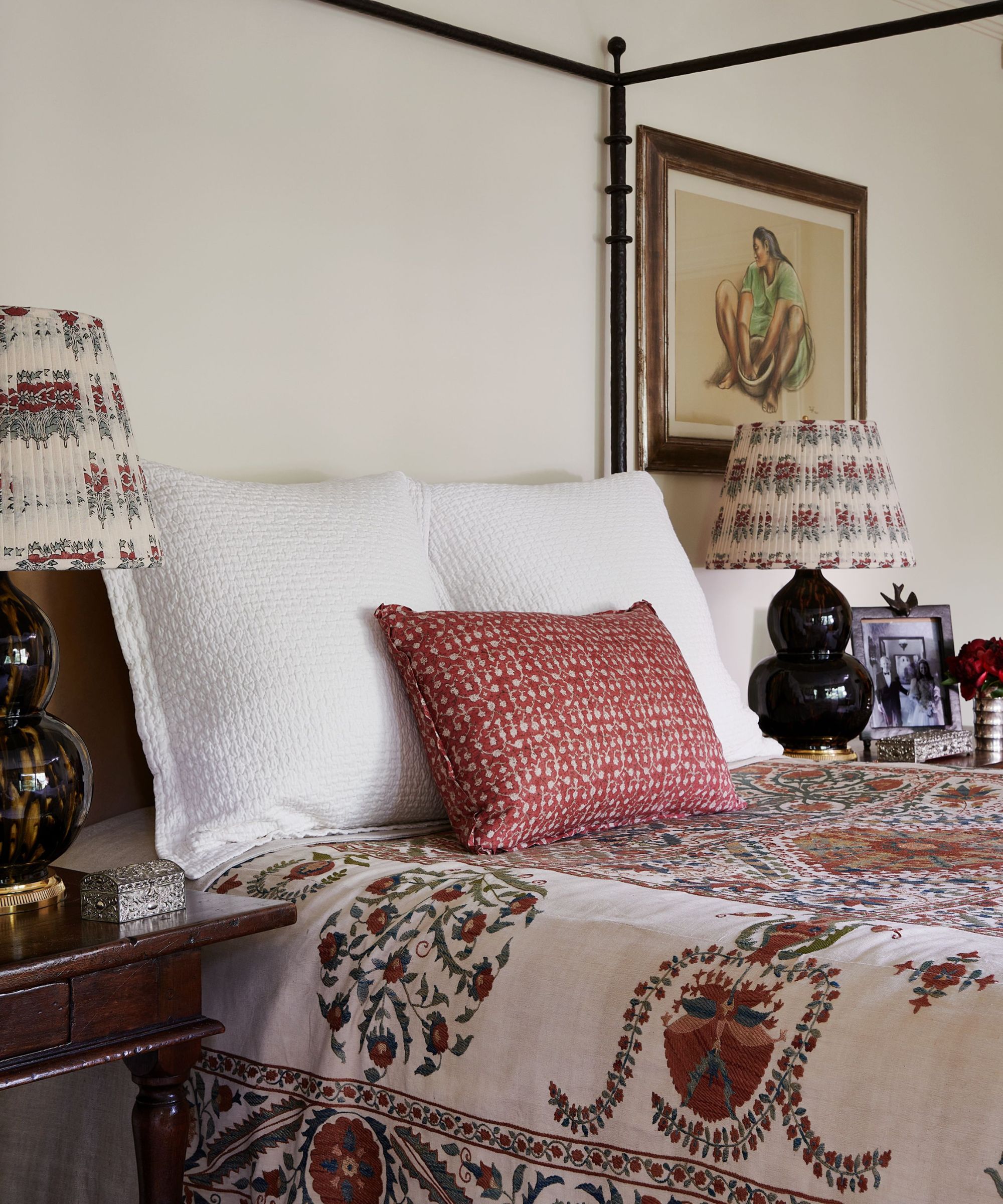 bedroom with black four poster and suzani coverlet