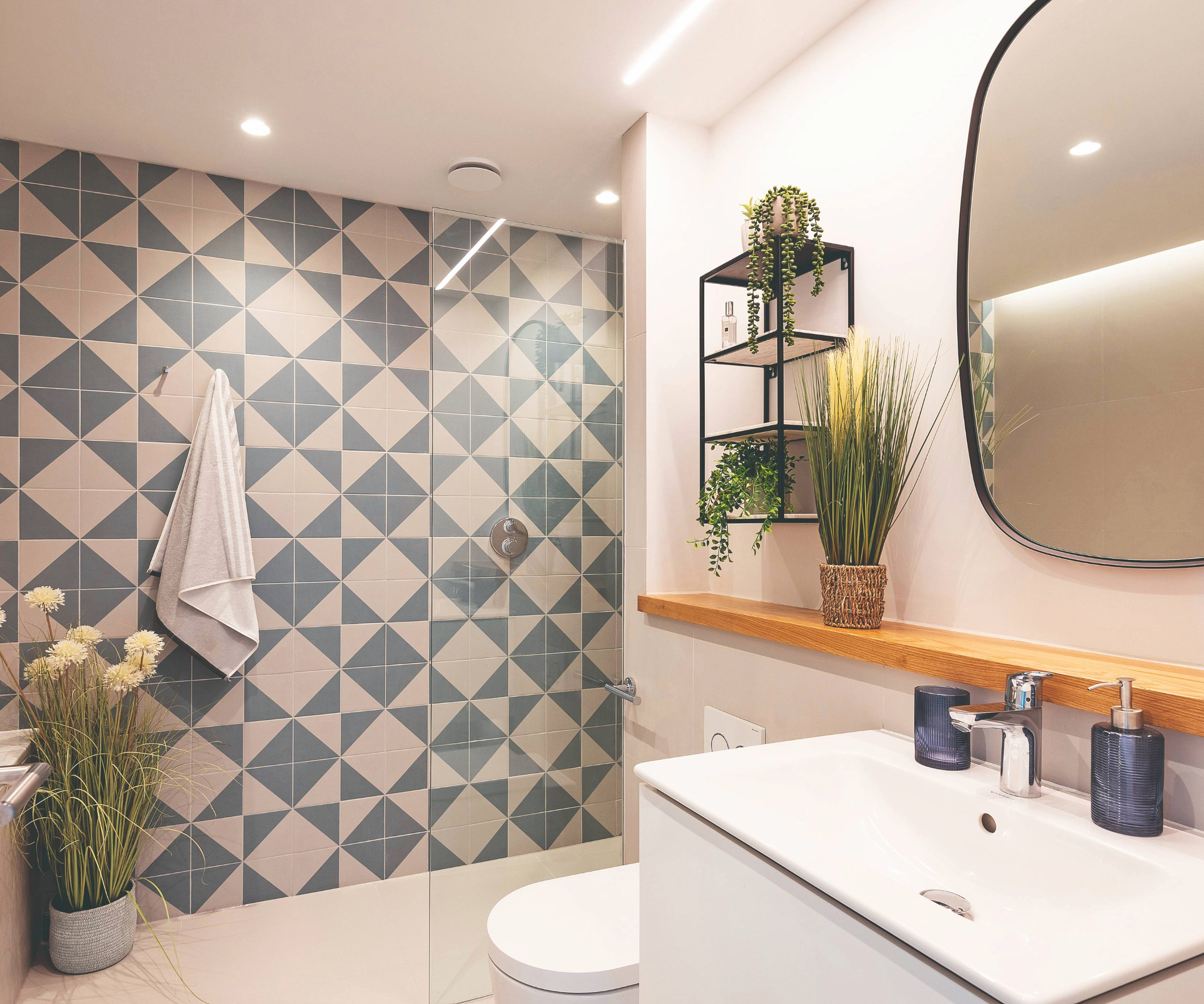 Shower room with toilet, sink and blue feature tiled wall