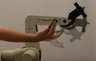 A wrist-joint of a 5 degree-of-freedom robotic manipulator mimics the forward and backward movement of the user holding an iPod touch. The iPod's accelerometer data is used to command the motion.