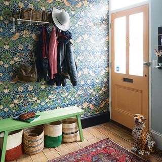 hallway with dark floral wallpaper and bench