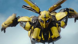 Still from the movie Transformers: Rise of the Beasts. Here we see the Transformer Bumblebee (yellow with wings) in flight mode.