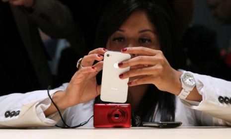 An Apple customer checks out the newly-released iPhone 4.