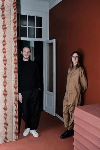 Designers ZanellatoBortotto stand in the doorway of an apartment