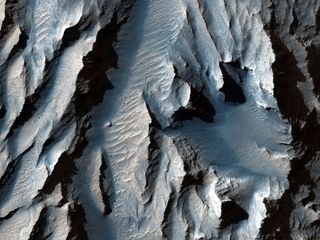 The Tithonium Chasma (part of Mars’ Valles Marineris) is slashed with diagonal lines of sediment that could indicate ancient cycles of freezing and melting.