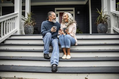 Couple enjoying coffee on the steps
