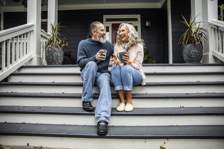 Couple enjoying coffee on the steps