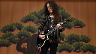 Marty Friedman playing guitar onstage