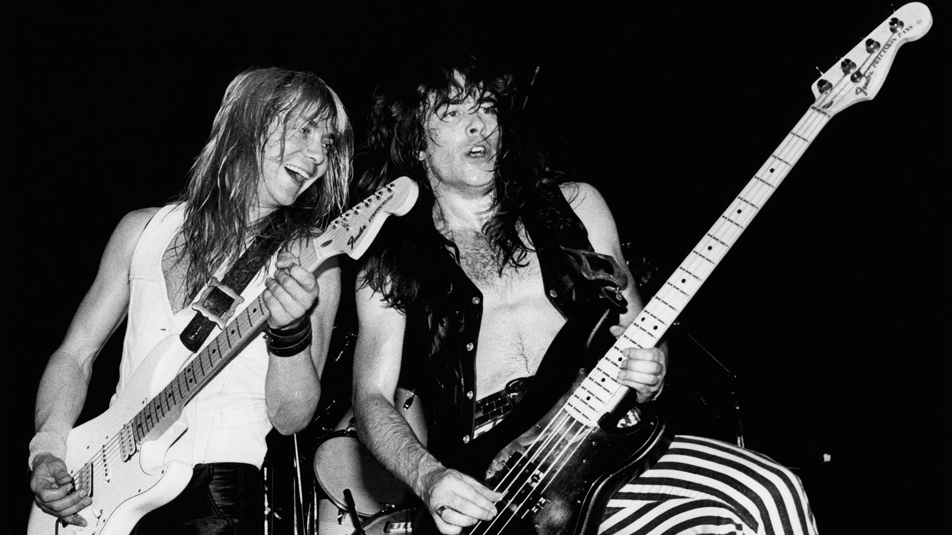 Black and white image of Dave Murray and Steve Harris performing live onstage on Killers World Tour on July 1, 1981