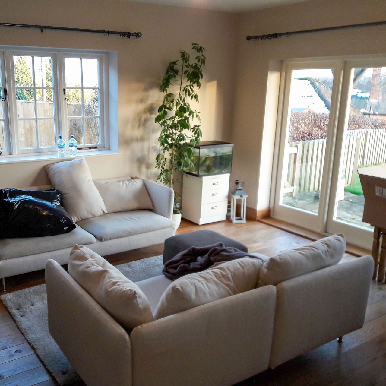 Neutral living room with French doors and two neutral sofas