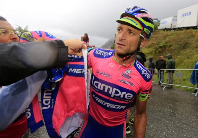 Michele Scarponi (Lampre-Merida) dons warm, dry clothes after a miserable day of racing in the Vuelta
