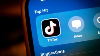 TikTok logo on a blue background on an iPhone