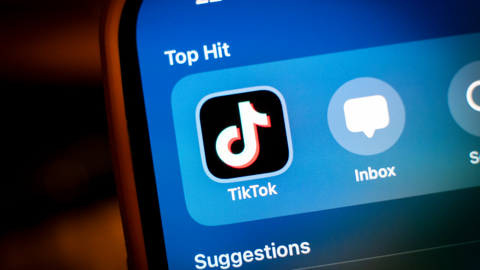 TikTok logo on a blue background on an iPhone