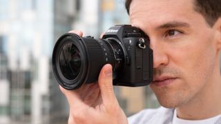 Gareth Bevan holding a Nikon Z6 III camera up to his face