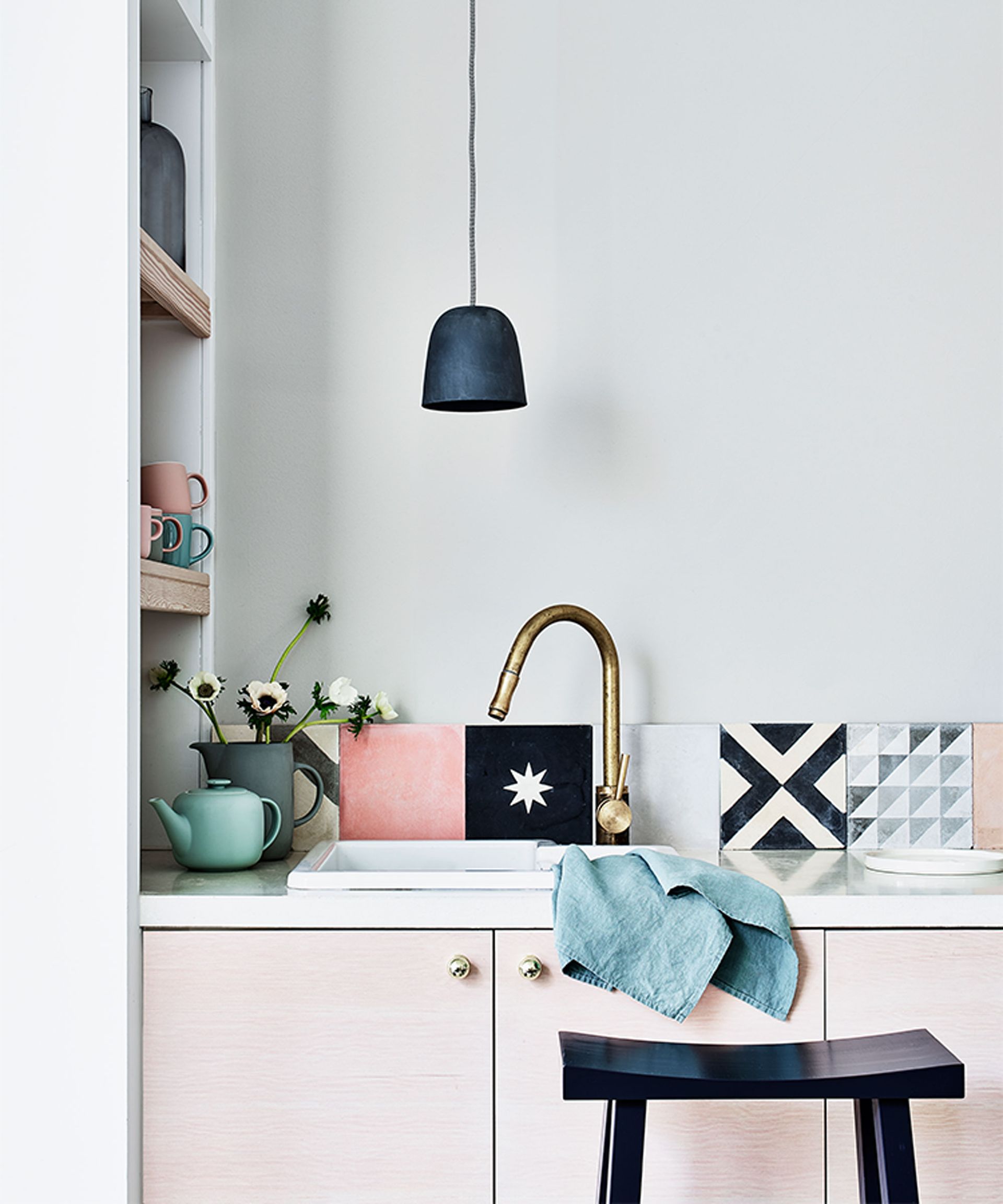 Kitchen wall decor with mismatched tiles in blue and pink