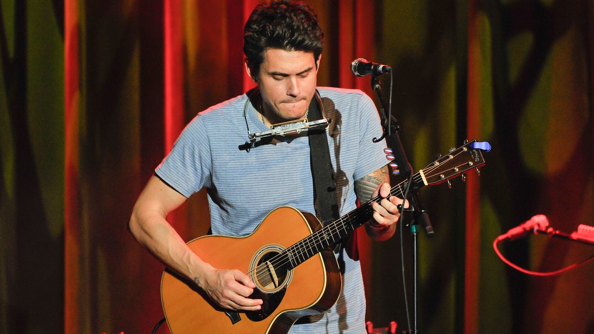 John Mayer playing a Martin acoustic guitar