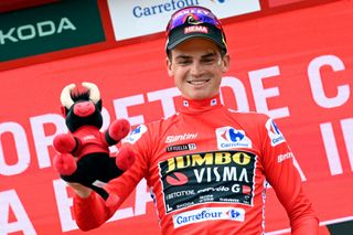 Team JumboVismas US rider Sepp Kuss celebrates on the podium wearing the overall leaders red jersey after the stage 8 of the 2023 La Vuelta cycling tour of Spain a 165 km race from Denia to Xorret de Cati in Castalla on September 2 2023 Photo by JOSE JORDAN AFP Photo by JOSE JORDANAFP via Getty Images