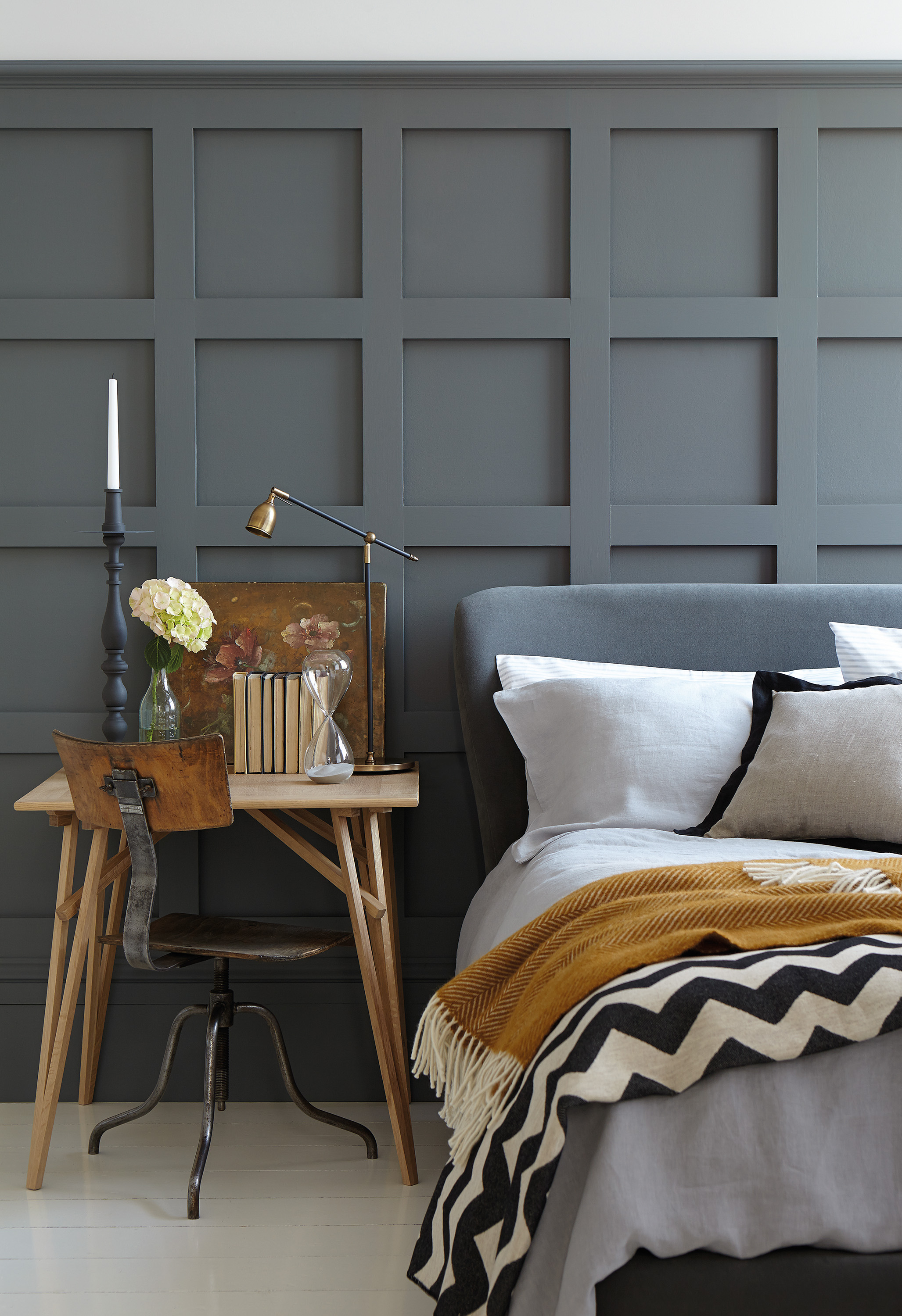 a panelled bedroom painted in grey