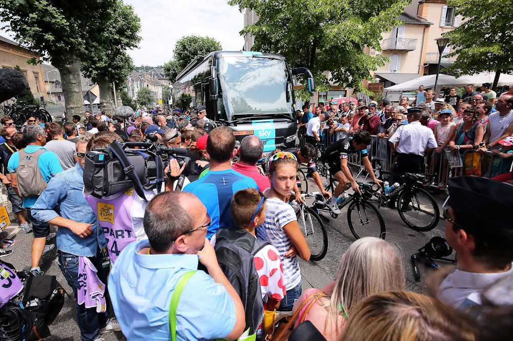 Sky riders warm up in front of their bus before the stage 15 start.