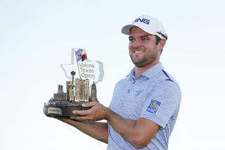 Corey Conners holds the Valero Texas Open trophy in 2019