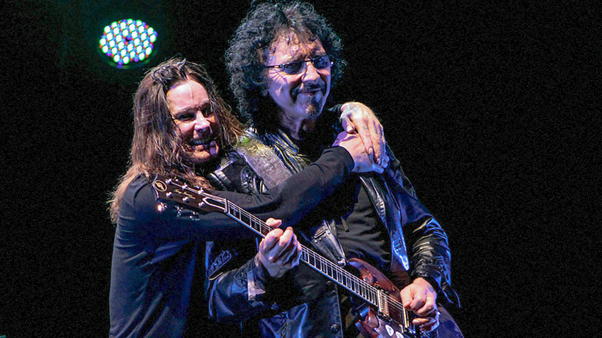 Ozzy Osbourne hugs Tony Iommi as Black Sabbath performs during the 13th tour at Apoteose Square, Sambodromo of Rio de Janeiro, October 13, 2013
