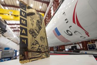 Tristan Eaton's "Human Kind" artwork, seen beside SpaceX Falcon 9 rockets at NASA's Kennedy Space Center in Florida.