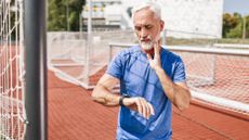 Senior athlete taking a break taking pulse