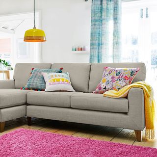 living room with white wall and sofaset with cushions