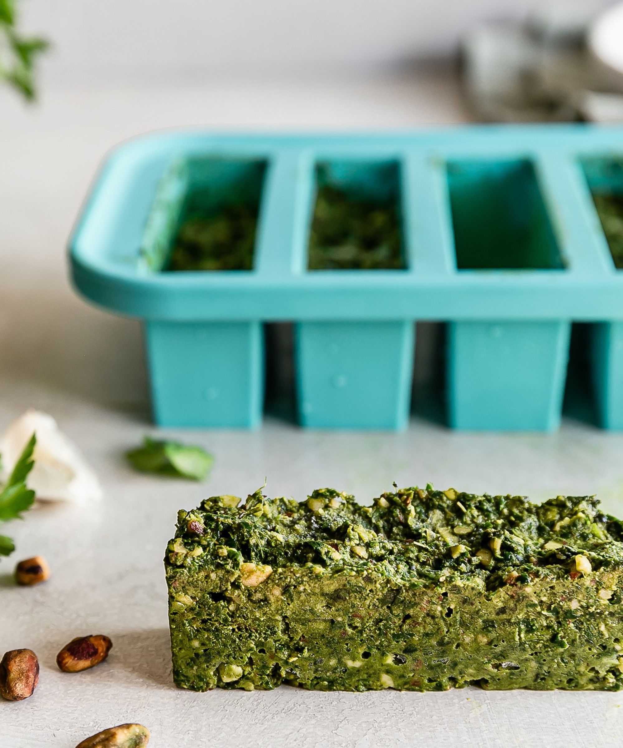 Souper Cube used for freezing half cups of green vegetables and herbsice cubes with lemon and blueberries