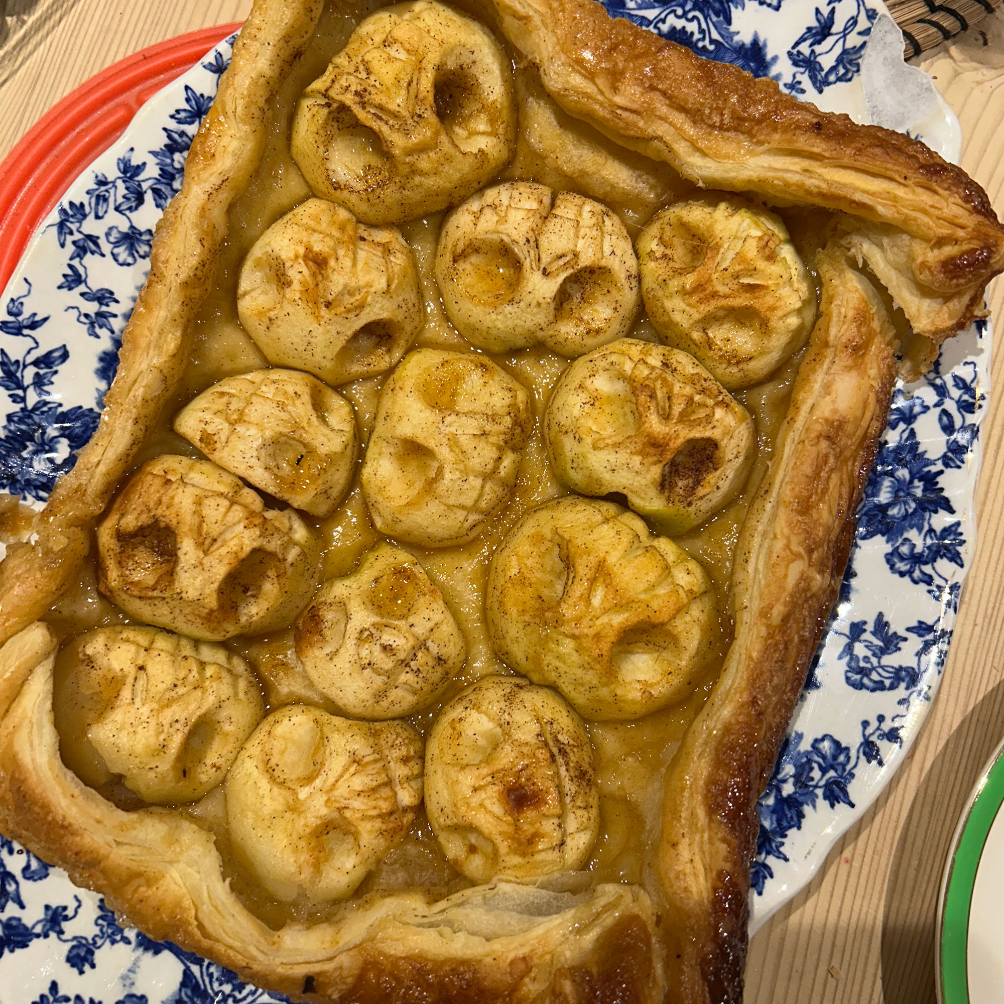 Apple tart on blue and white floral patterned platter