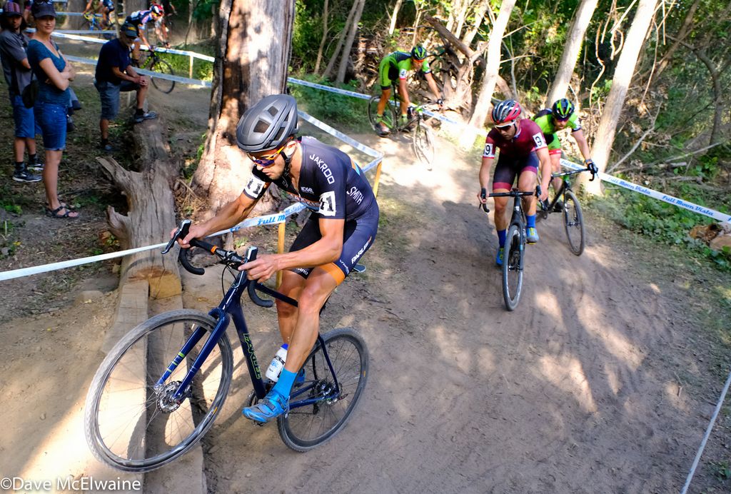 Danny Summerhill (Maxxis Shimano) bunny-hopping some log steps in the woods.