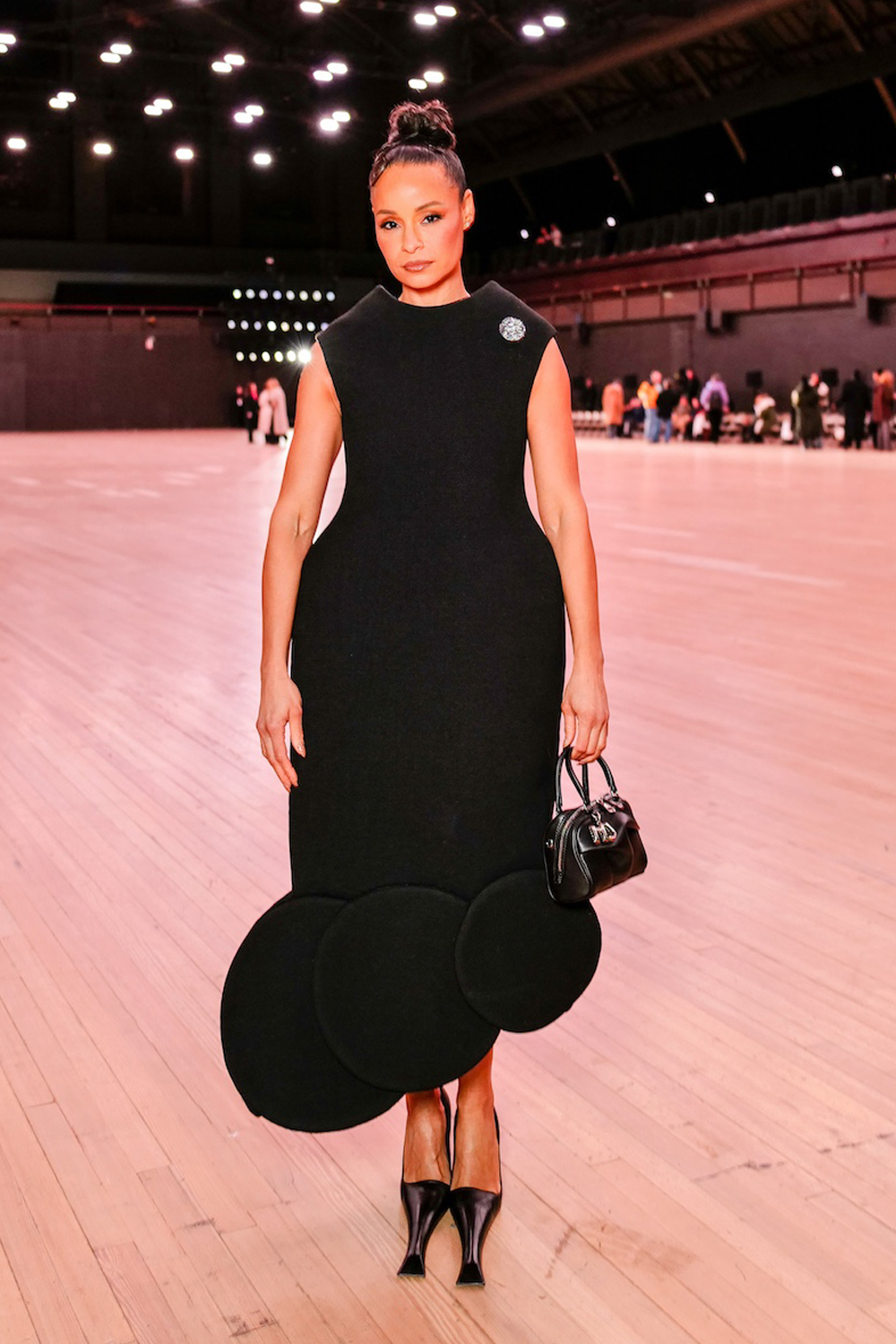 Sai De Silva poses wearing a voluminous black dress with fashion-forward black pumps during the Marc Jacobs spring 2026 fashion show during NYFW.