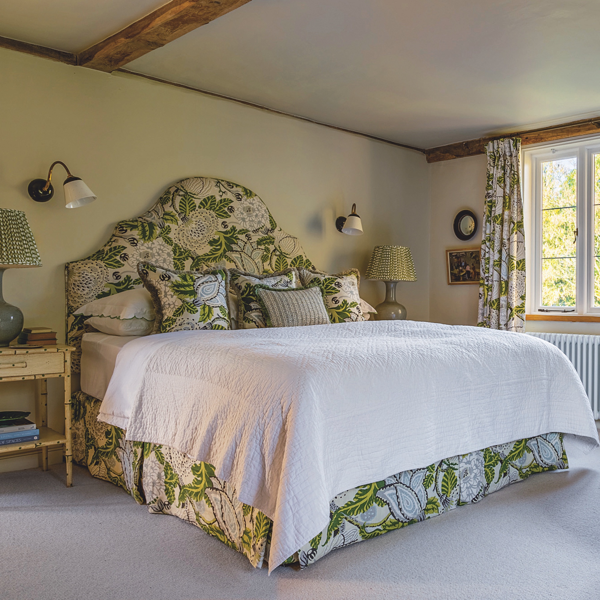bedroom with double bed with green leaf pattern upholstered headboard