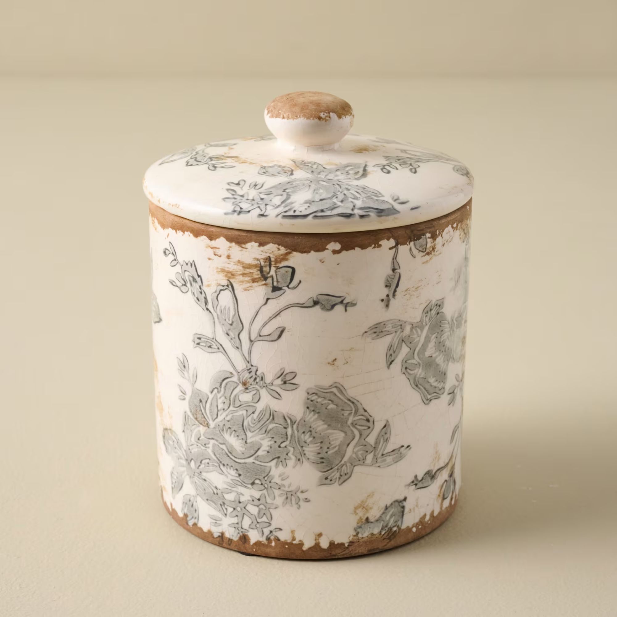 Vintage style cannister with blue and white worn floral design
