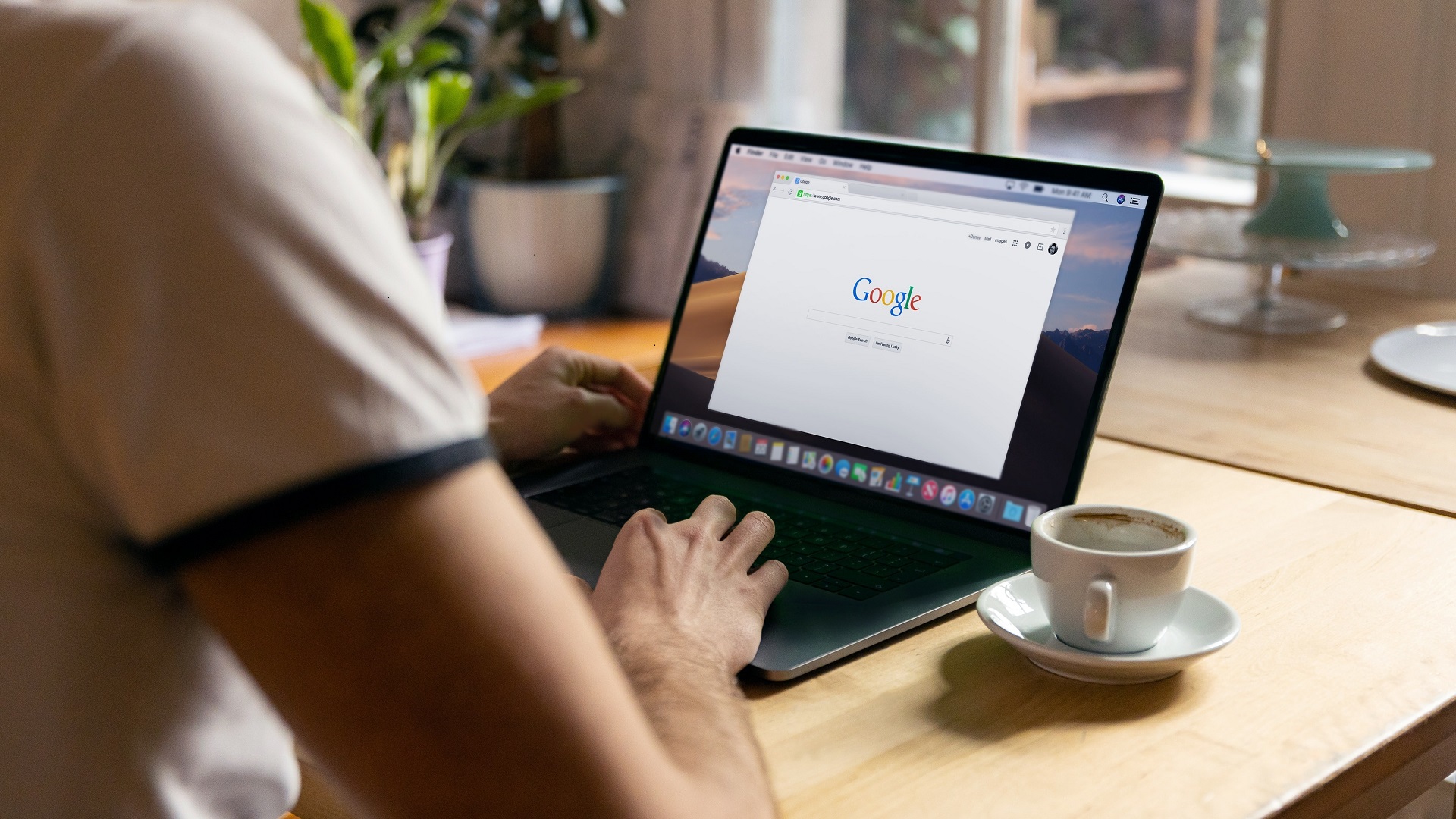 Man pictured from behind performing a Google search