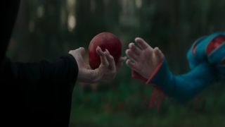 The old crone handing Snow White the poison apple