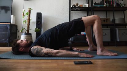 Man taking a yoga class at home