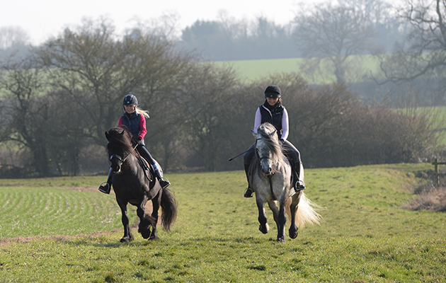 Alice Tomlinson riding Jack and Steph Britain riding Mr P having a hack around the fields around Katy Marriot Payne stables in a small Northampton Village in the UK on the 13th February 2017