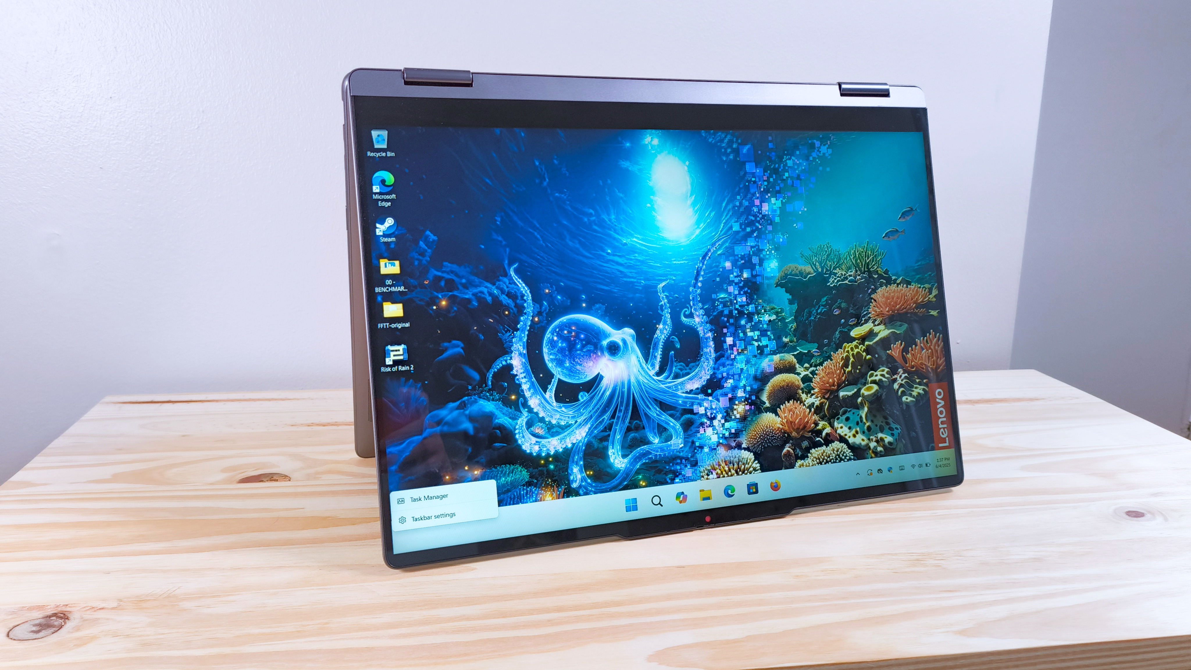 The Lenovo Yoga 7i 2-in-1 16 on a wood table in tablet mode