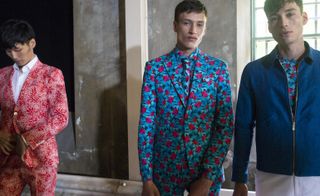 Male models wearing the Richard James collection for Spring / Summer 2016 with stylised colorful hibiscus blooms from deep within the Mexican jungle