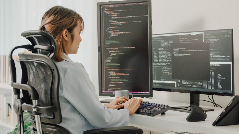 Female java developer using desktop computer at a desk while working remotely.